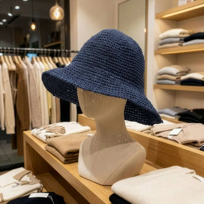 Navy blue crocheted bucket hat made of straw sun material shown against a plain background for casual wear
