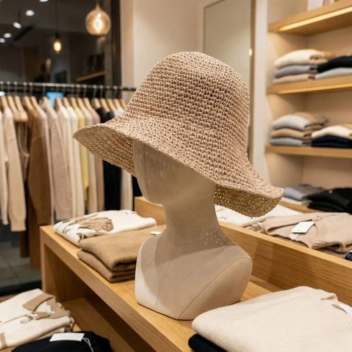 Beige woven straw sun hat with wide brim and subtle texture in rose blush color perfect for sun protection