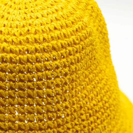 Bright yellow woven straw sun hat with a textured interlaced pattern for sun protection