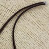 Dark brown suede leather cord necklace with sterling silver fittings and silver-toned metal clasps shown on white background