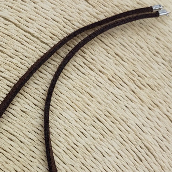 Dark brown suede leather cord necklace with sterling silver fittings and silver-toned metal clasps shown on white background