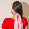 A pink and white striped summer scarf tied around the head with a flowing tail showing perfect pink style