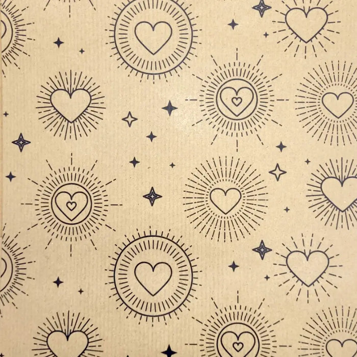Beige recycled kraft gift wrap with black heart sunburst patterns and scattered stars in a 1m by 50cm sheet