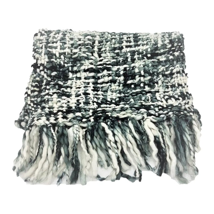 A chunky knit black and white tweed scarf made of super soft 100 percent acrylic with fringed edges