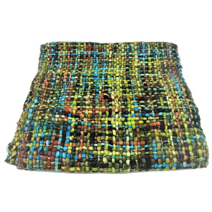 A colorful handwoven acrylic snood with a textured pattern in green blue black and earthy tones
