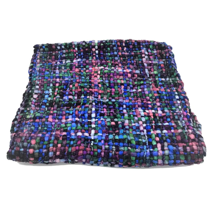A colorful textured acrylic snood scarf in blues pinks greens and purples made from super soft acrylic yarn