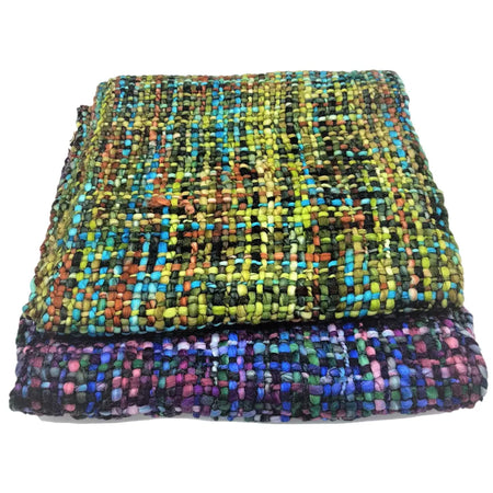 Stacked acrylic snoods with vibrant multicolored woven patterns in soft acrylic textile showing visible texture