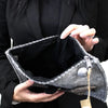 Gray felt tablet pouch with hand-stitched edge silver zipper pull and fuzzy pom-pom featuring finger puppets