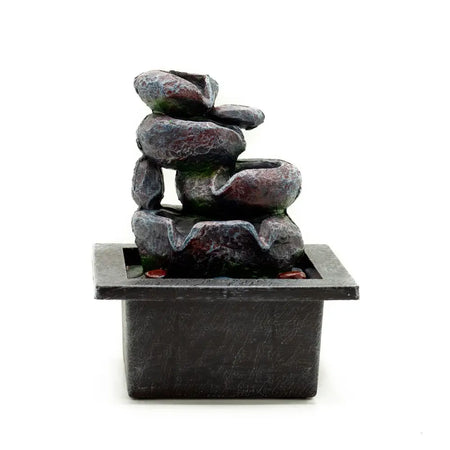 Dark gray resin tabletop water feature with cascading pots and stacked textured stone tiers on a square base