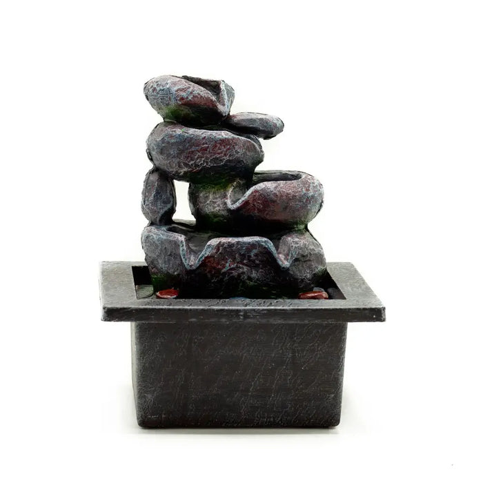 Dark gray resin tabletop water feature with cascading pots and stacked textured stone tiers on a square base