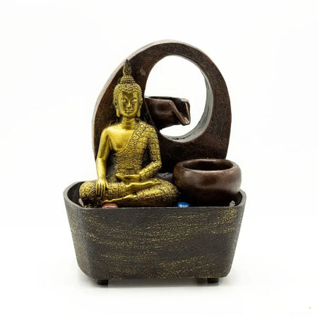 Golden buddha figurine seated in a dark brown textured fountain base with an oval arch on a tabletop water feature
