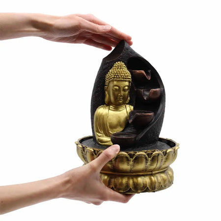 Golden buddha tabletop water feature with cascading water in a dark resin shell on a gold lotus base
