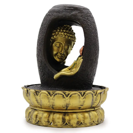 Golden buddha head tabletop water feature with dark stone casing and lotus shaped base in vitarka mudra pose