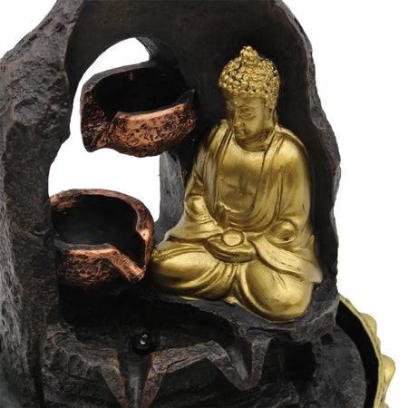 Golden meditating buddha tabletop water feature with dark rocky fountain and copper toned water basins