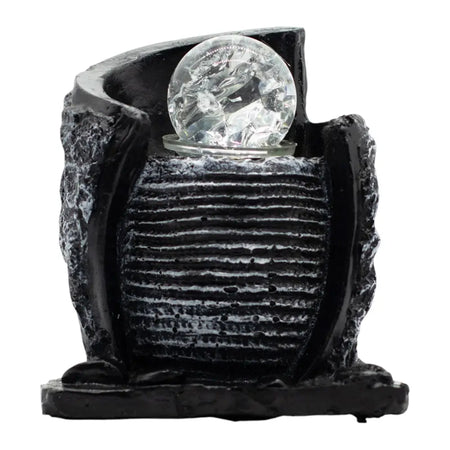 Black resin tabletop water feature with textured water pot basin and clear faceted crystal ball on top