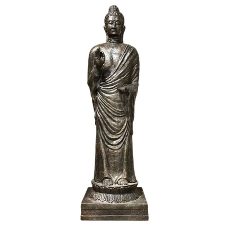 Silver toned antique gold standing buddha statue with detailed robes on a lotus base made from metallic material