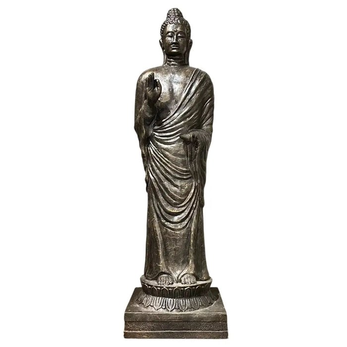 Silver toned antique gold standing buddha statue with detailed robes on a lotus base made from metallic material