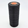 Black tall ribbed wooden tealight holder with textured surface and orange tealight in top circular opening