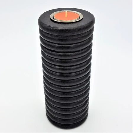 Black tall ribbed wooden tealight holder with textured surface and orange tealight in top circular opening