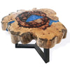 Rustic coffee table with tamarind wood top and blue resin tree ring design on black metal legs