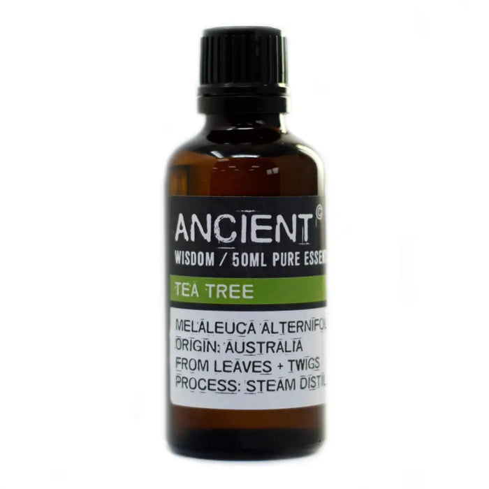 A 50ml amber glass bottle of ancient wisdom tea tree essential oil with black cap and melaleuca alternifolia label