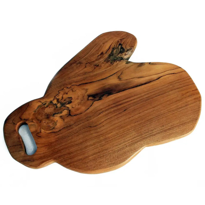Teak chopping board handcrafted from rich olive wood with natural irregular shape and dark grain patterns