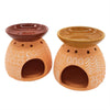 Two terracotta oil burners with hand-painted white patterns and glazed brown tops used as wax melt warmers
