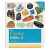The crystal bible 3 by judy hall is a hardcover book with a white cover showing colorful crystal images in a grid layout