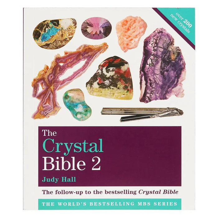 The crystal bible 2 by Judy Hall is a hardcover book with a white cover featuring colorful crystals and purple text