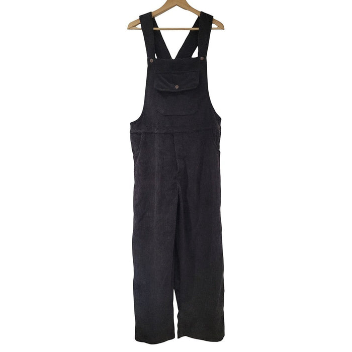 The Window, Milford Haven black jumbo cord dungarees with front pocket and adjustable straps on a wooden hanger.