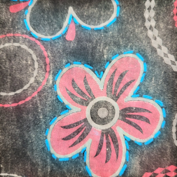The Window, Milford Haven black cotton hooded top featuring a pink and blue floral circle print pattern.