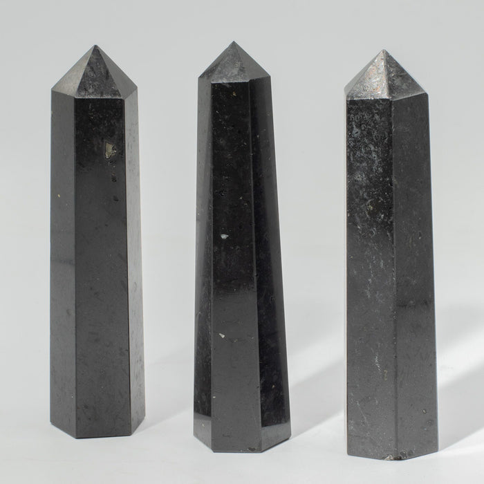 Three polished black tourmaline six-face obelisk points from The Window, Milford Haven for grounding and protection.