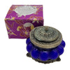 The Window, Milford Haven Song Of India Nag Champa blue pumpkin-shaped glass candle in an ornate white metal jar.