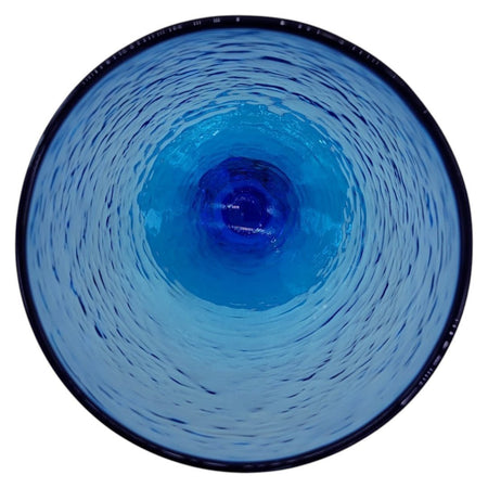 Top-down view of a The Window, Milford Haven ice blue recycled glass wine glass with a textured hammered finish.