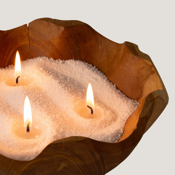 The Window, Milford Haven Blush Bloom candle sand with three lit wicks in a rustic wooden bowl