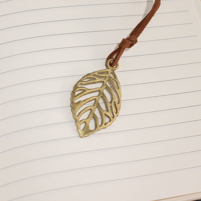 The Window, Milford Haven notebook featuring a brass-coloured leaf bookmark on lined paper pages.
