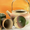 The Window, Milford Haven ceramic Japanese kyusu teapot and matching cups with a green and beige speckled glaze