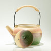 The Window, Milford Haven ceramic kyusu teapot with a rope-wrapped handle and a multi-coloured green and brown lid.