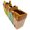 The Window, Milford Haven ceramic planter shaped like a row of colourful pastel townhouses with brown roofs.