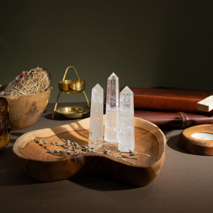 The Window, Milford Haven clear quartz six-face obelisk points displayed on a wooden tray with dried lavender.