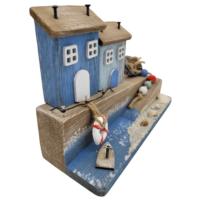 The Window, Milford Haven decorative wooden coastal ornament featuring blue cottages, a miniature boat, and seashells.