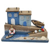The Window, Milford Haven decorative wooden coastal ornament with blue cottages, miniature boat, and real seashells.