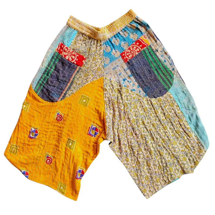 The Window, Milford Haven cropped cotton Kantha trousers featuring a yellow waistband and vibrant patchwork patterns.