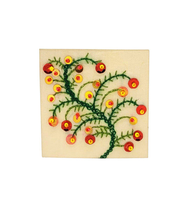 The Window, Milford Haven hand-embroidered Christmas card featuring a green branch motif with red and gold sequins.