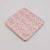 The Window, Milford Haven square mango wood coaster with a delicate pink and green floral pattern on a white background