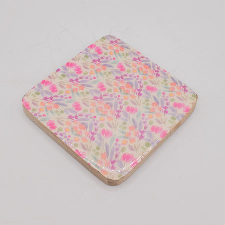 The Window, Milford Haven square mango wood coaster with a delicate pink and green floral pattern on a white background