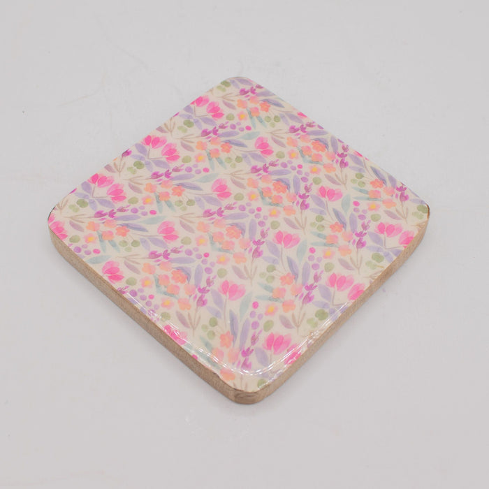The Window, Milford Haven square mango wood coaster with a delicate pink and green floral pattern on a white background
