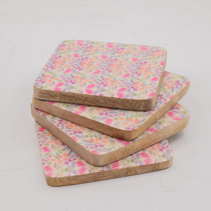 The Window, Milford Haven set of four square mango wood coasters featuring a delicate pink and green floral pattern.