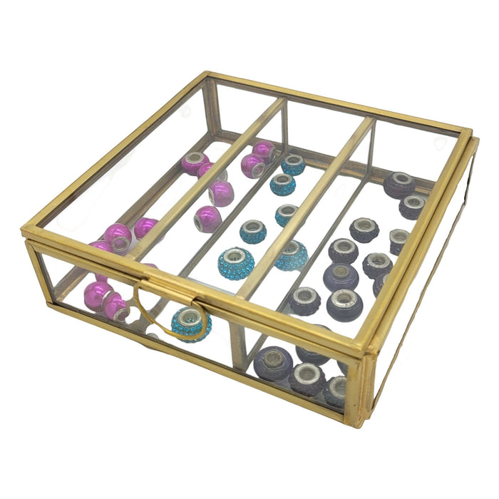 The Window, Milford Haven large square glass jewellery box with gold metal frame and internal dividers holding beads.