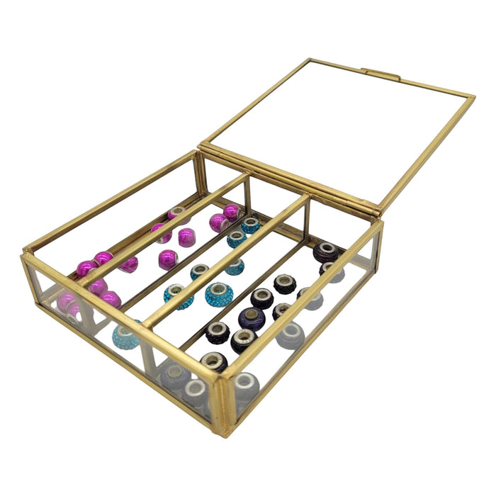 The Window, Milford Haven large glass and metal jewellery box with a hinged lid, containing various colourful beads.